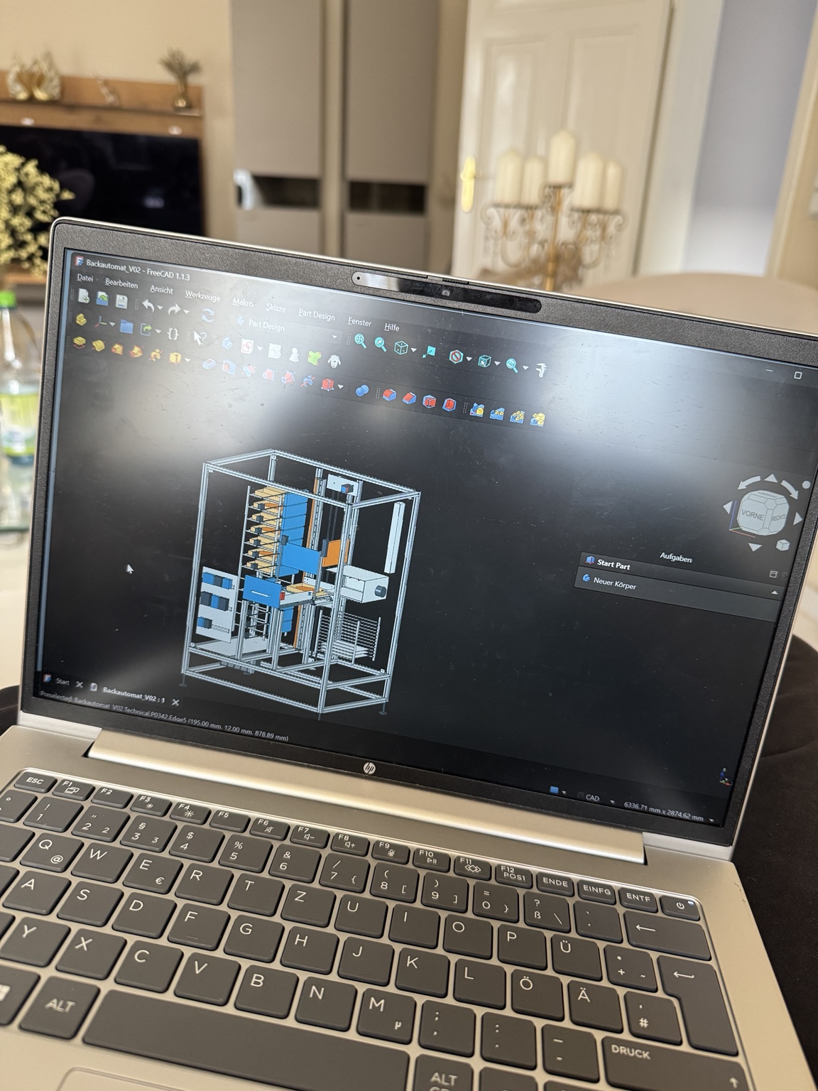 CAD-Entwurf des Automaten mit Lager und Transportmechanik auf einem Laptopbildschirm